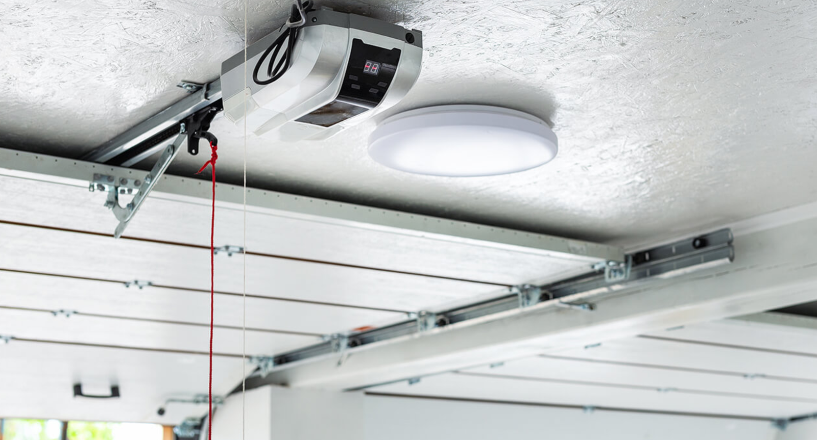 Black and white image of a closed industrial garage door with corrugated metal exterior.