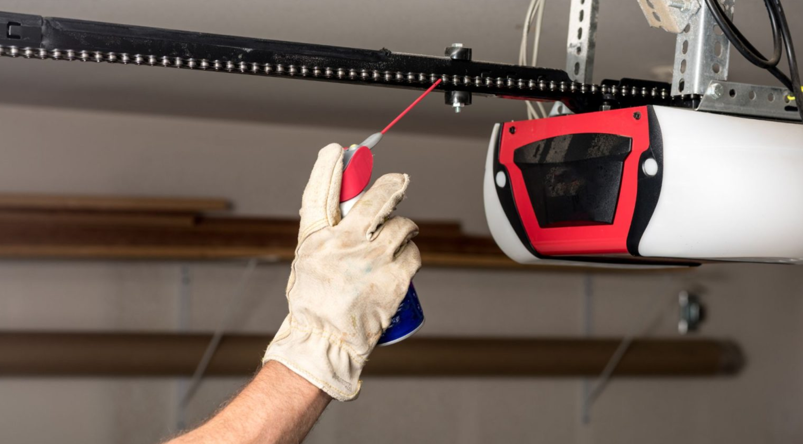 Two closed garage doors inside an empty warehouse space.