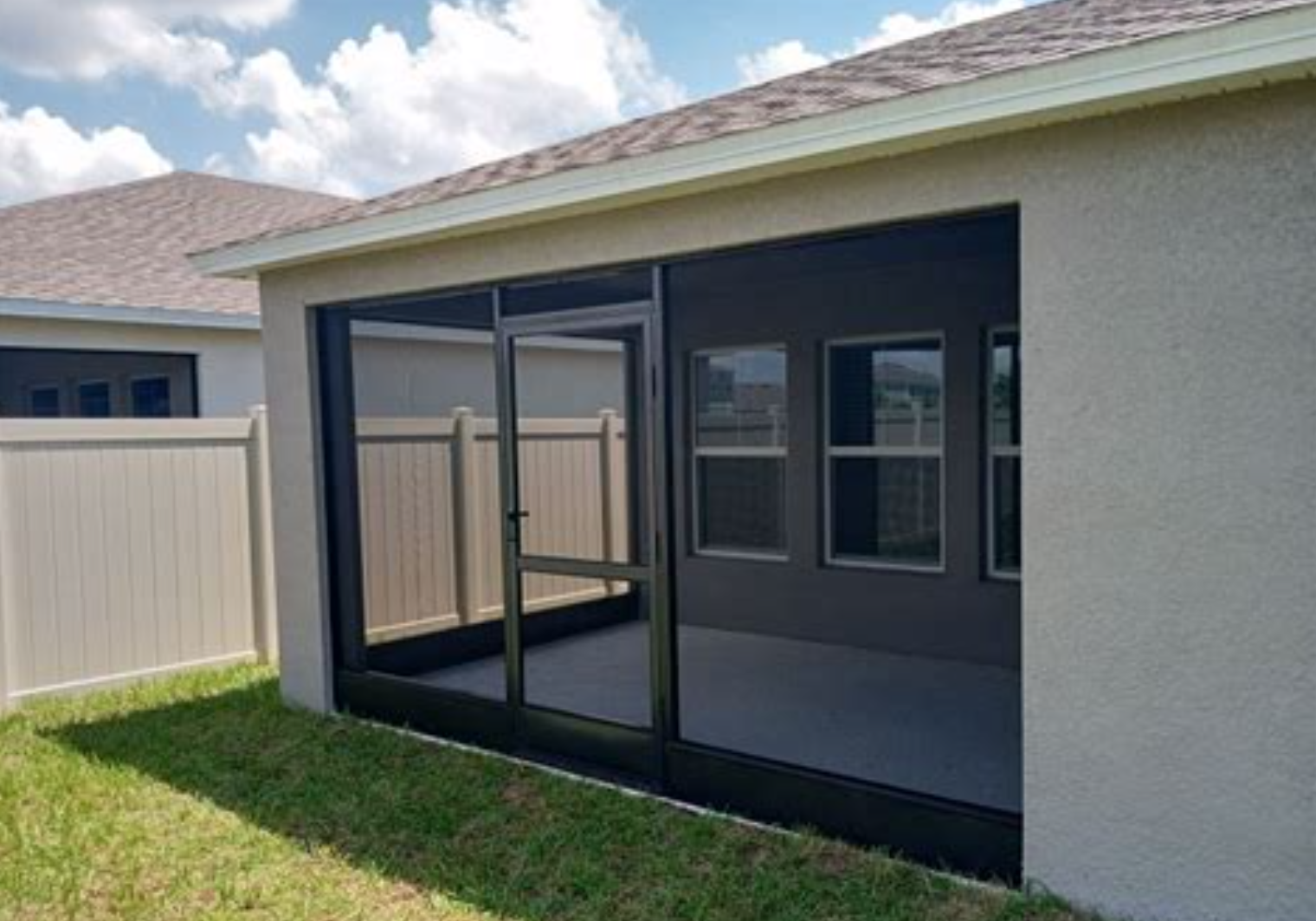Aerial view of vibrant autumn leaves over a shaded patio area with green umbrellas.